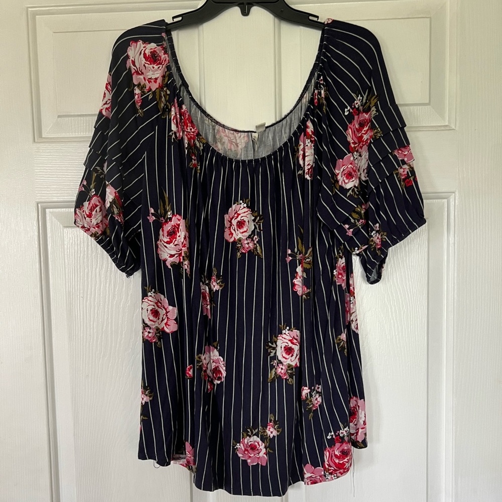 Navy off the shoulder top with pink floral print and ruffled sleeves.